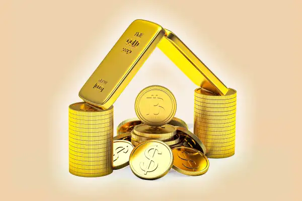 Gold bars and Bitcoins forming the shape of a house